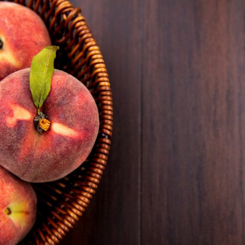 top-view-fresh-delicious-peaches-bucket-wood-with-copy-space.jpg